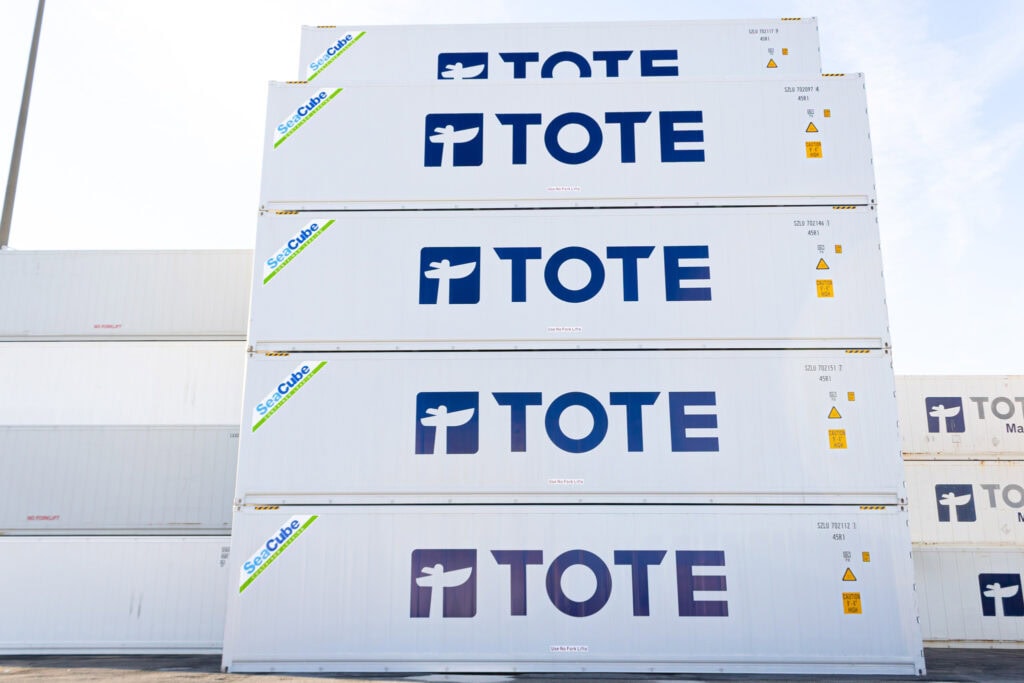 Tote boxes stacked outdoors with "TOTE" logo on each box.