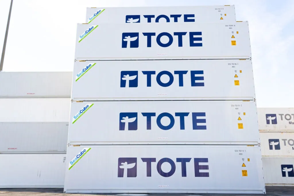 Tote boxes stacked outdoors with "TOTE" logo on each box.