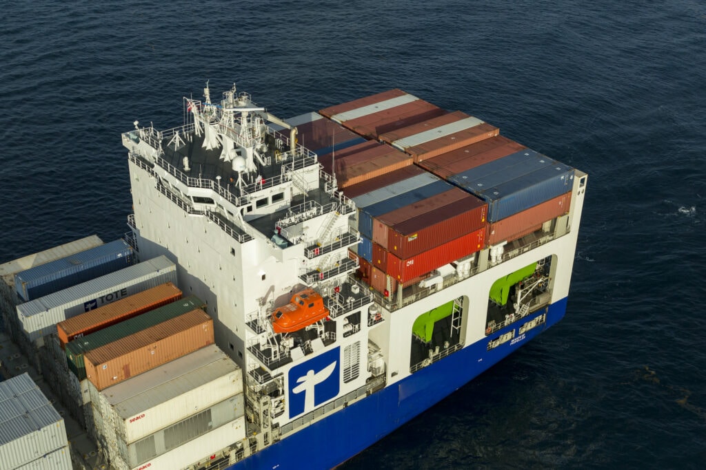 Cargo ship carrying containers on the ocean.