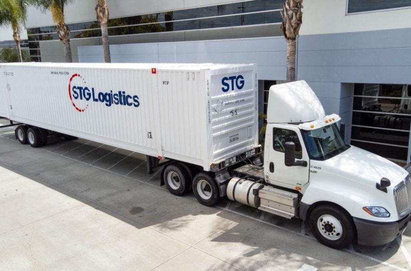 STG Logistics truck parked outside a building.